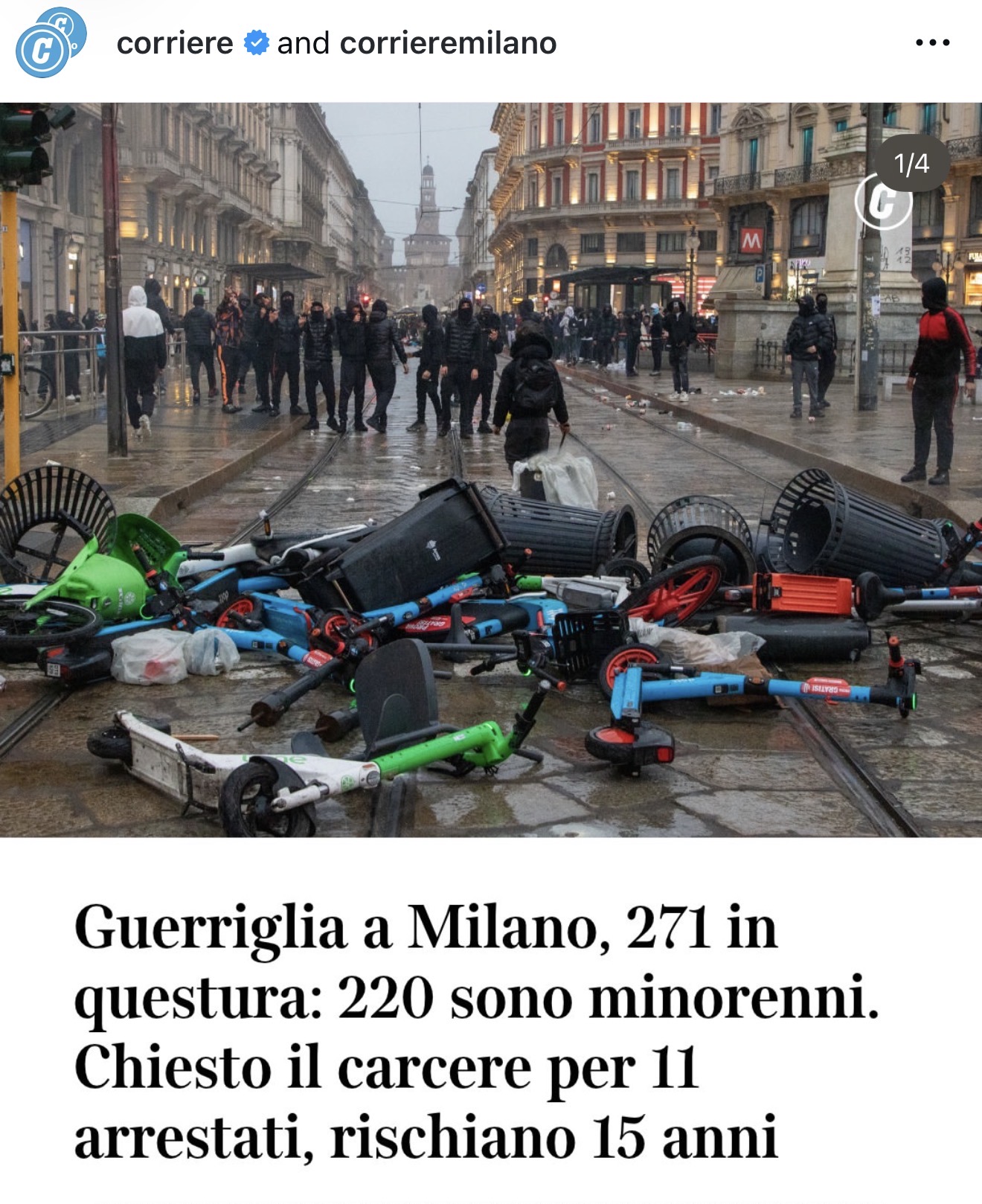 Street unrest in central Milan, with overturned scooters and refuse bins in the foreground.